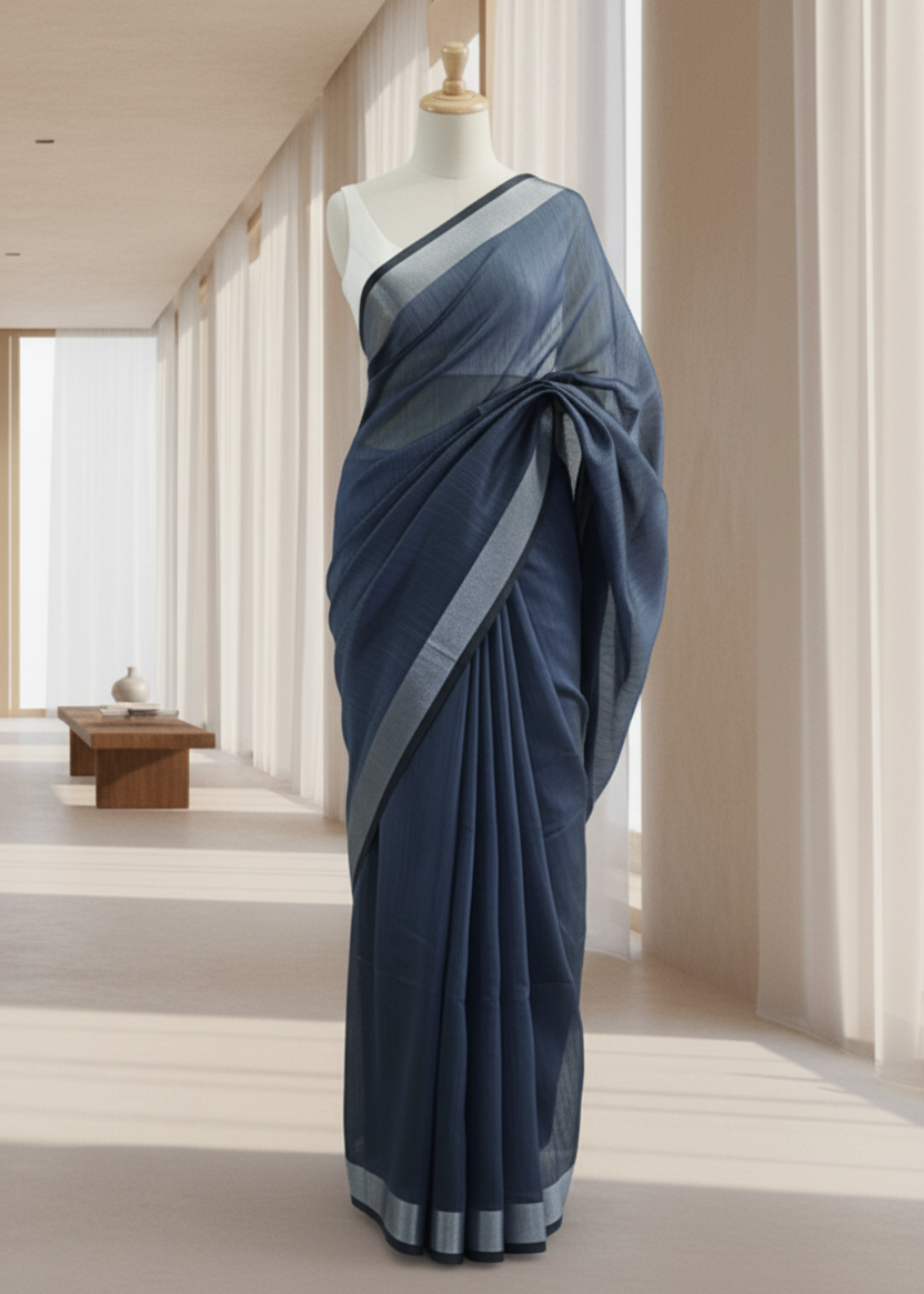 Navy blue cotton saree with a gray border on a mannequin against a neutral background