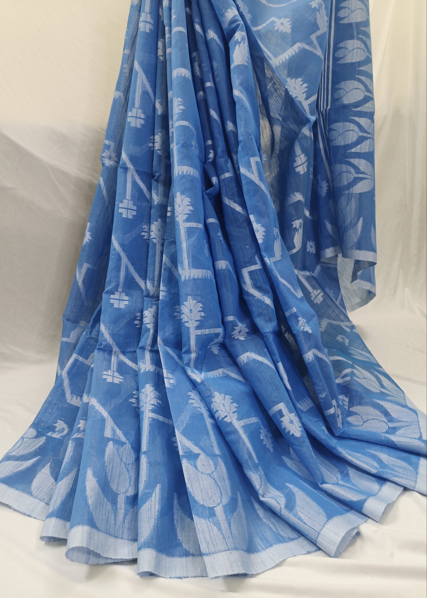 Blue fabric with white patterns on a white background