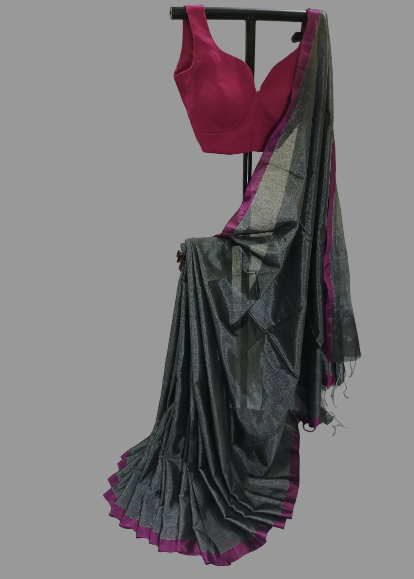 Gray saree with purple border draped over a stand against a white background
