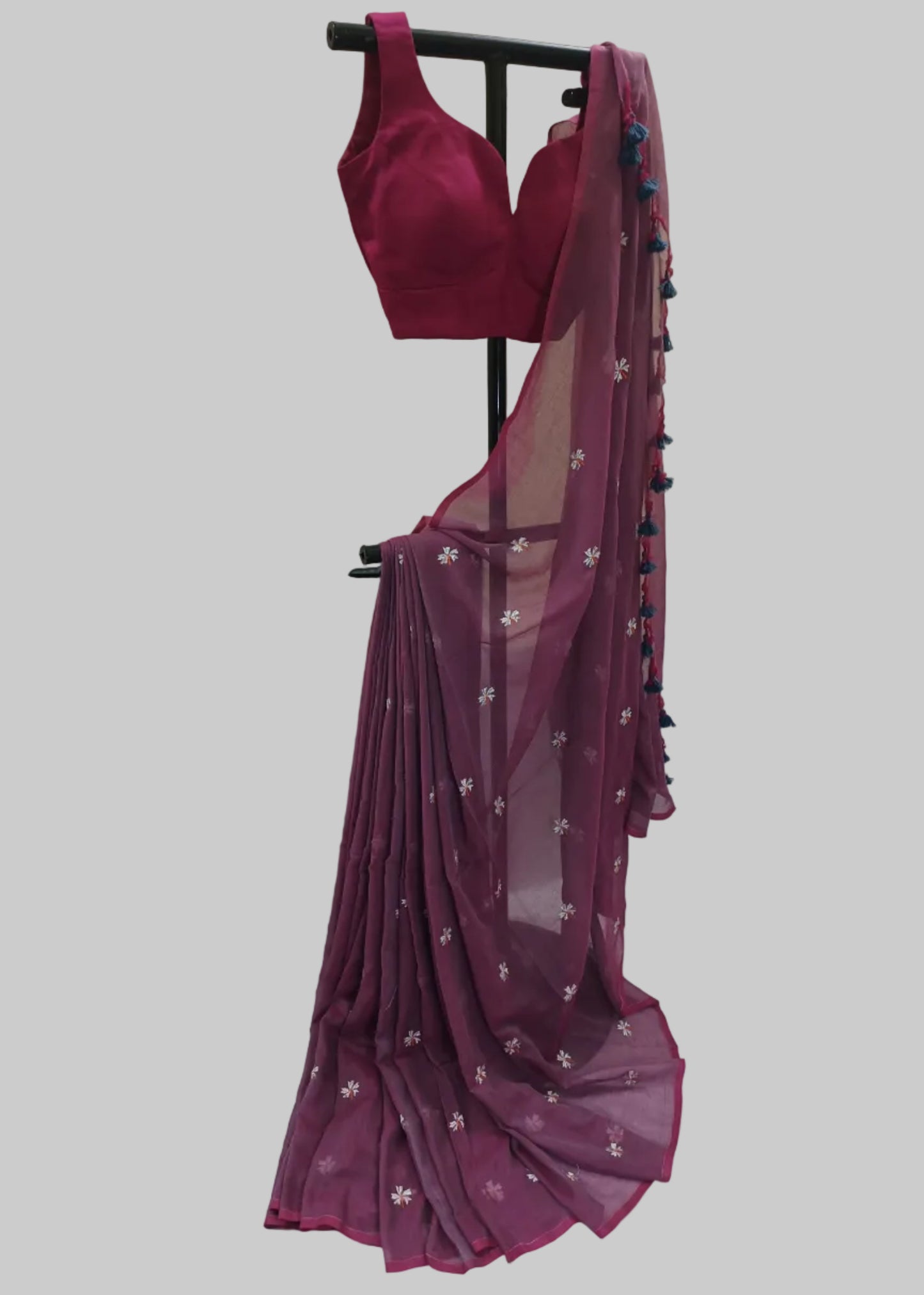 Magenta saree with floral patterns on a white background