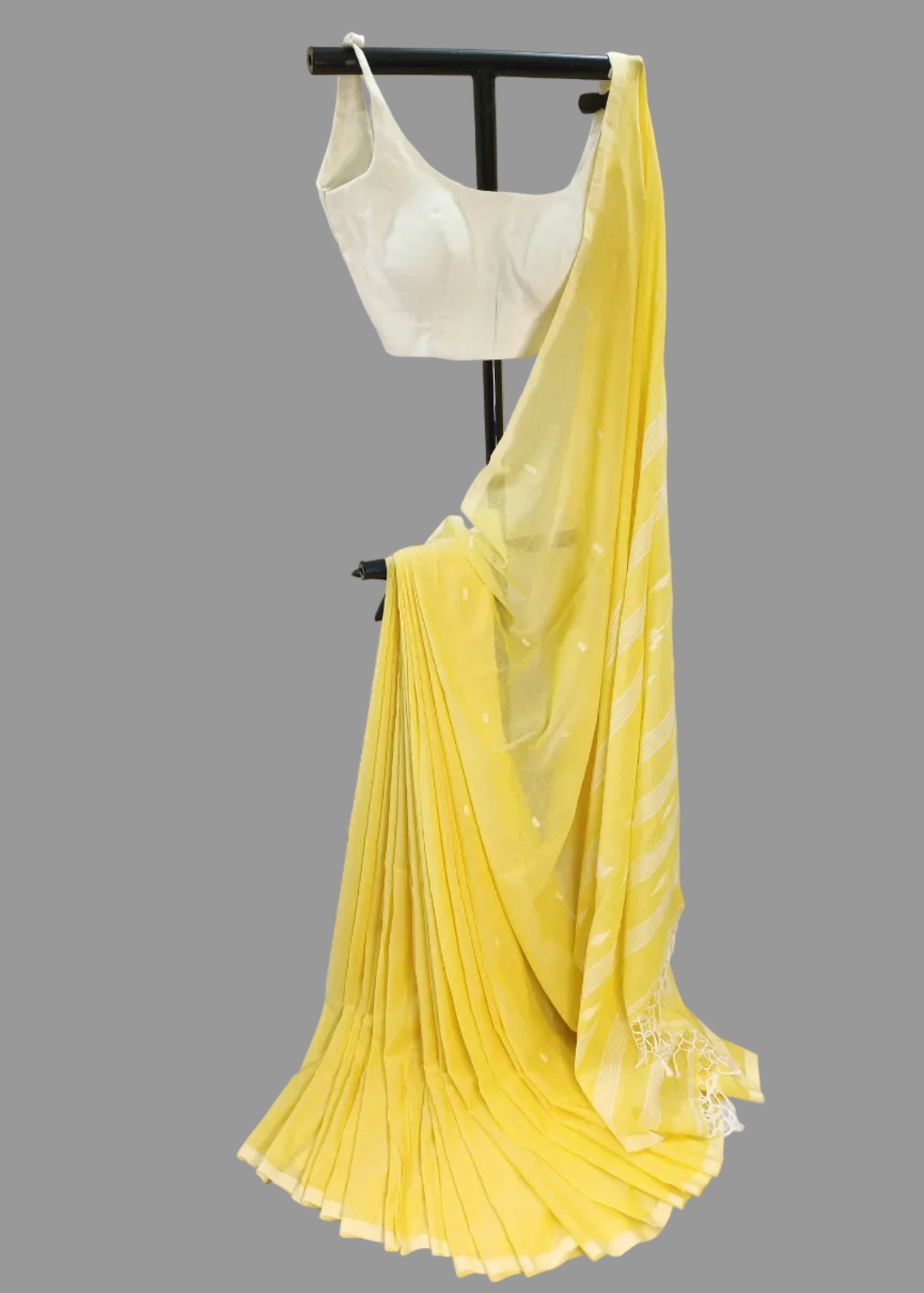Yellow saree draped over a mannequin with a white background