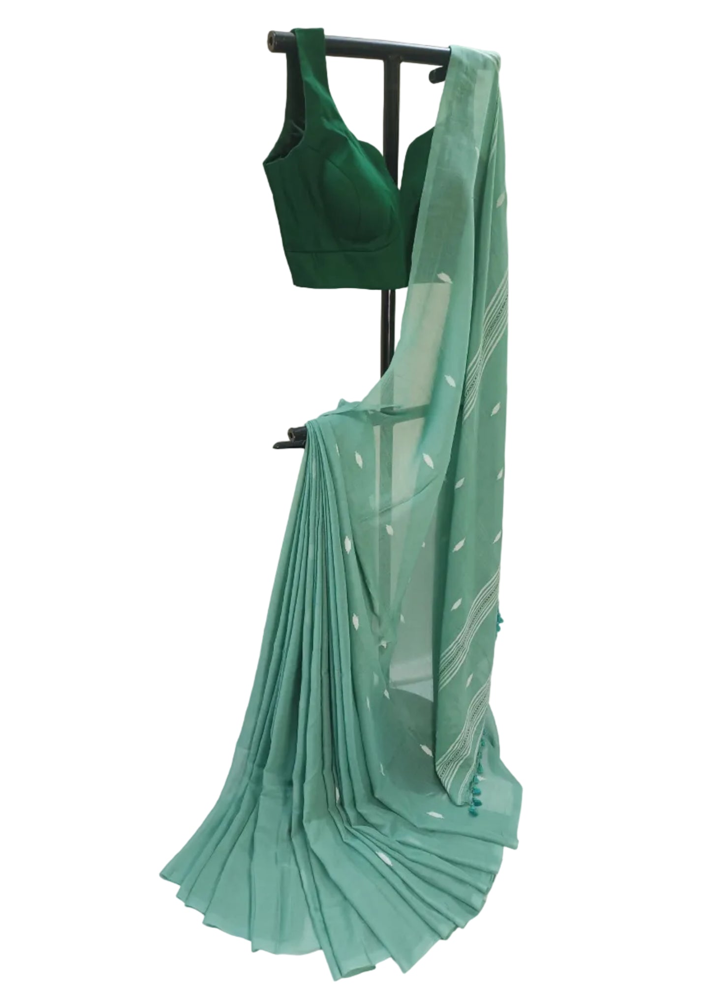 Green saree and blouse on a stand against a white background