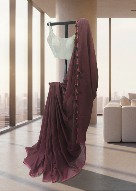 Mannequin with a white top and maroon saree in a modern room with large windows.