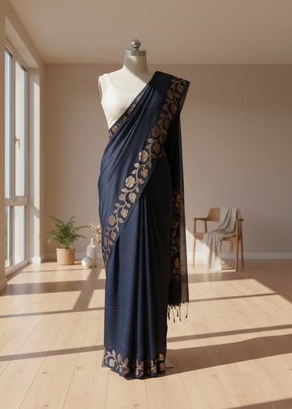 Navy blue linen saree with gold patterns on a mannequin in a well-lit room.
