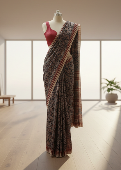 kalamkari cotton Saree on a mannequin with a red blouse in a bright room.