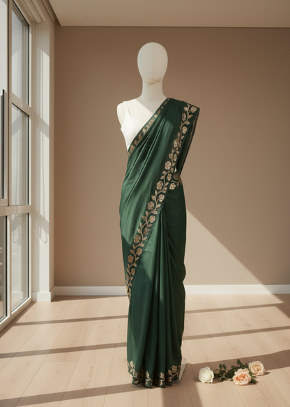 Green linen saree with floral embroidery on a mannequin against a beige wall.