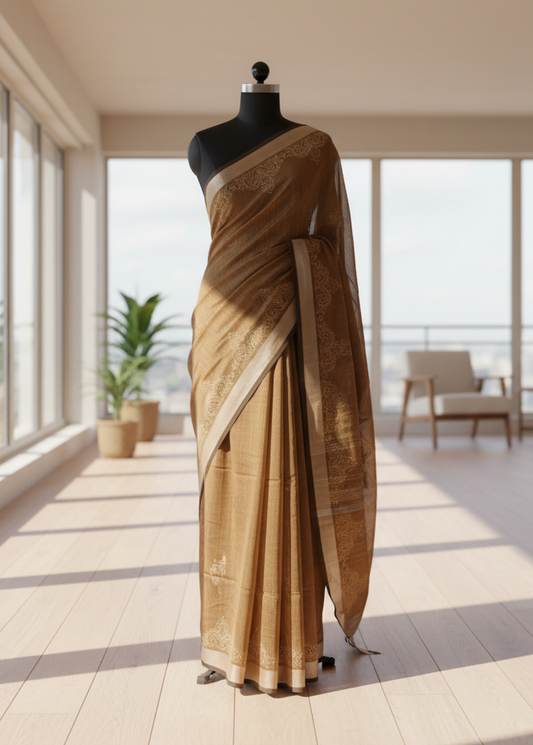 Brown saree on a mannequin against a bright room background