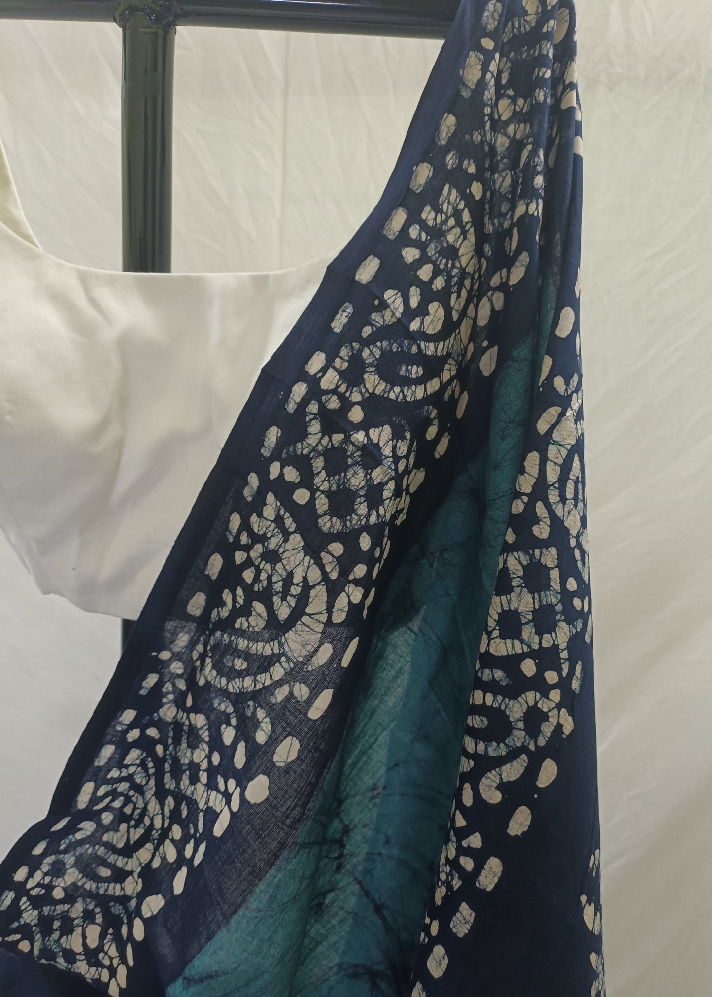 Navy blue fabric with intricate white patterns on a white background
