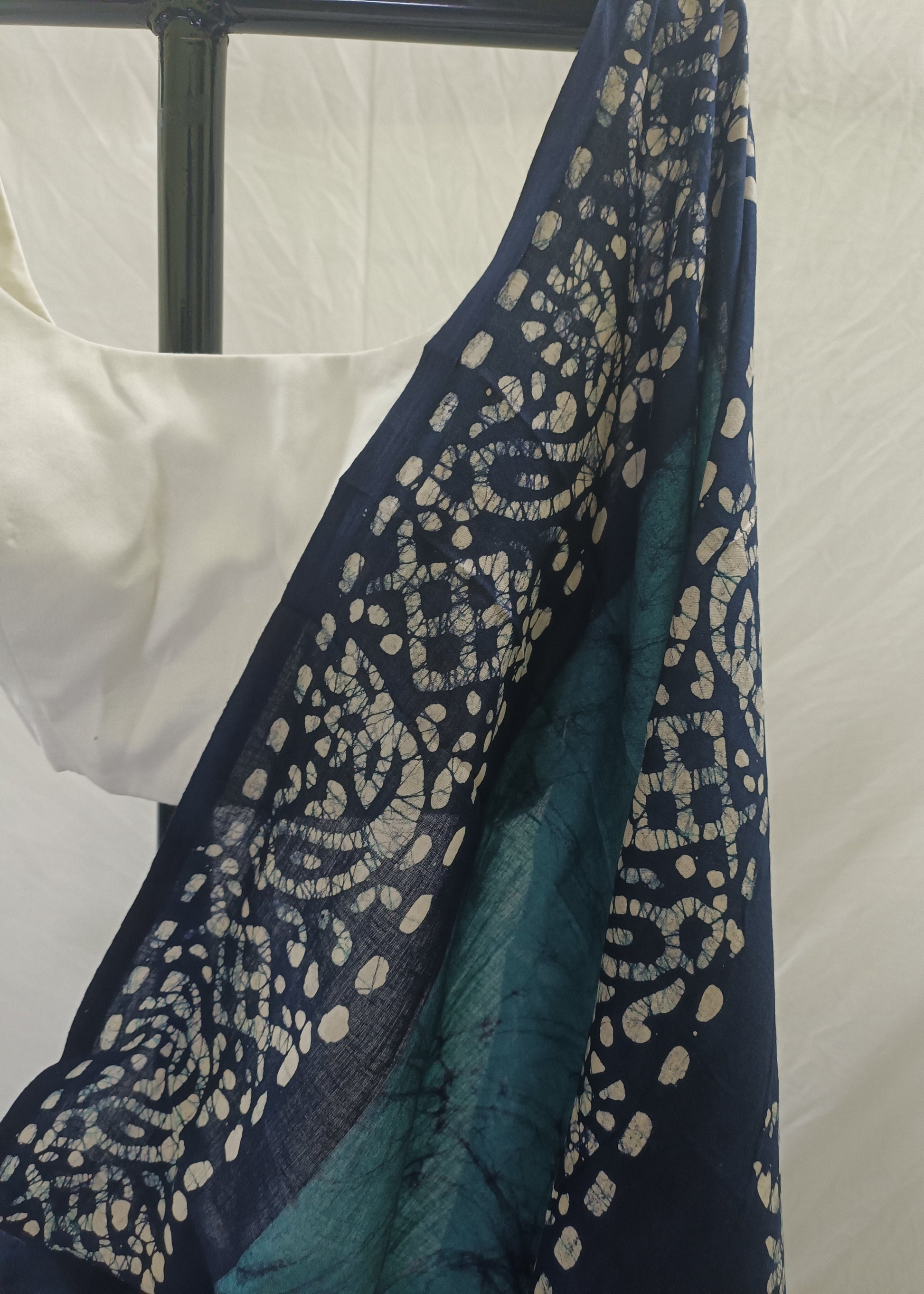 Navy blue fabric with intricate white patterns on a white background