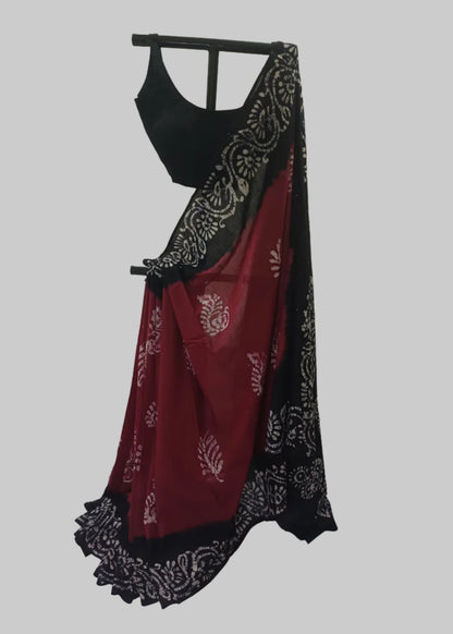 Black and red saree with white patterns on a white background