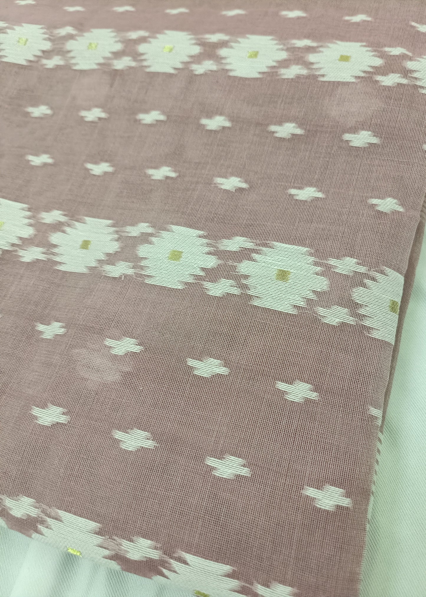 Fabric with a floral pattern on a pink background