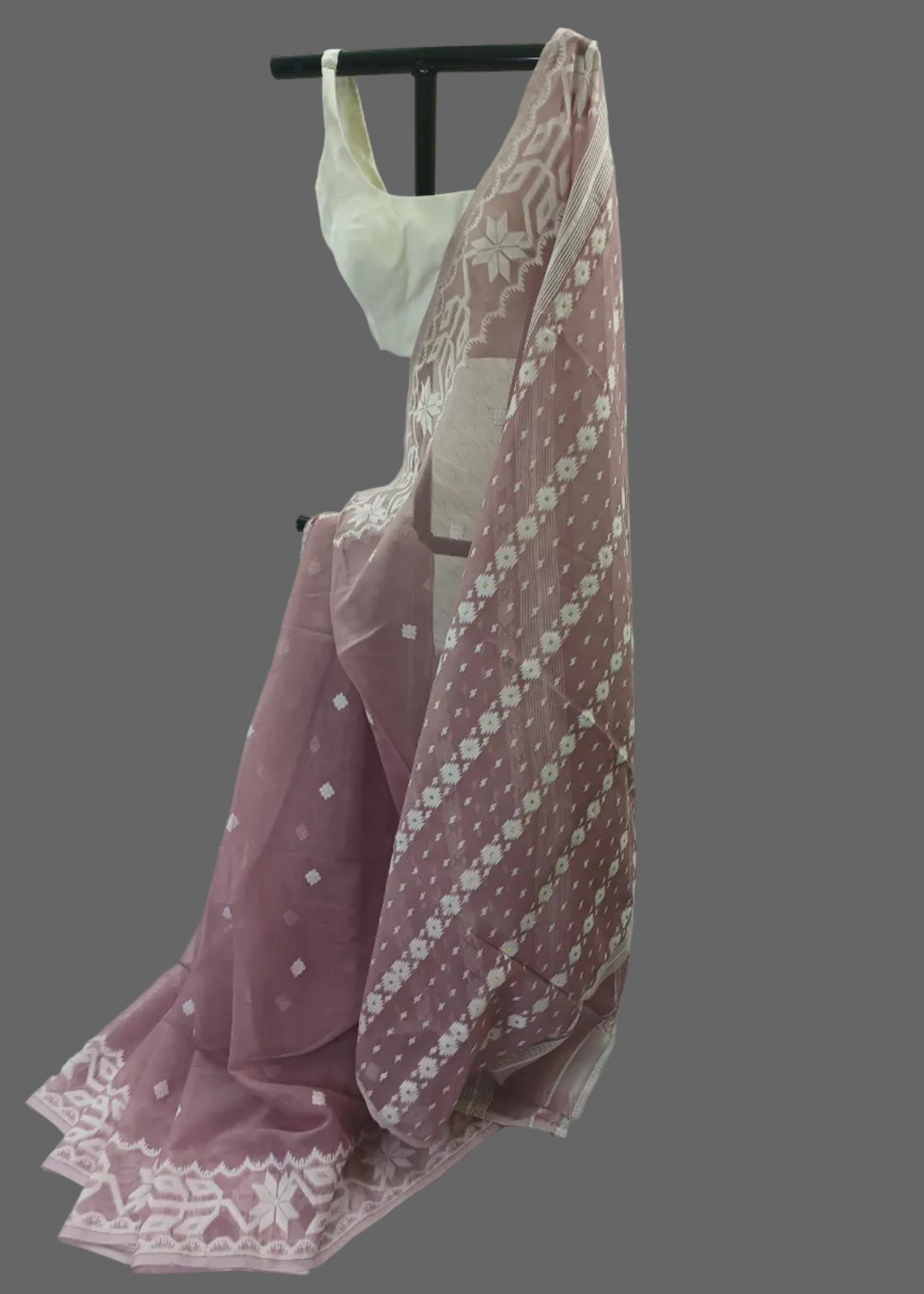 Pink floral dress with a white lace overlay on a white background