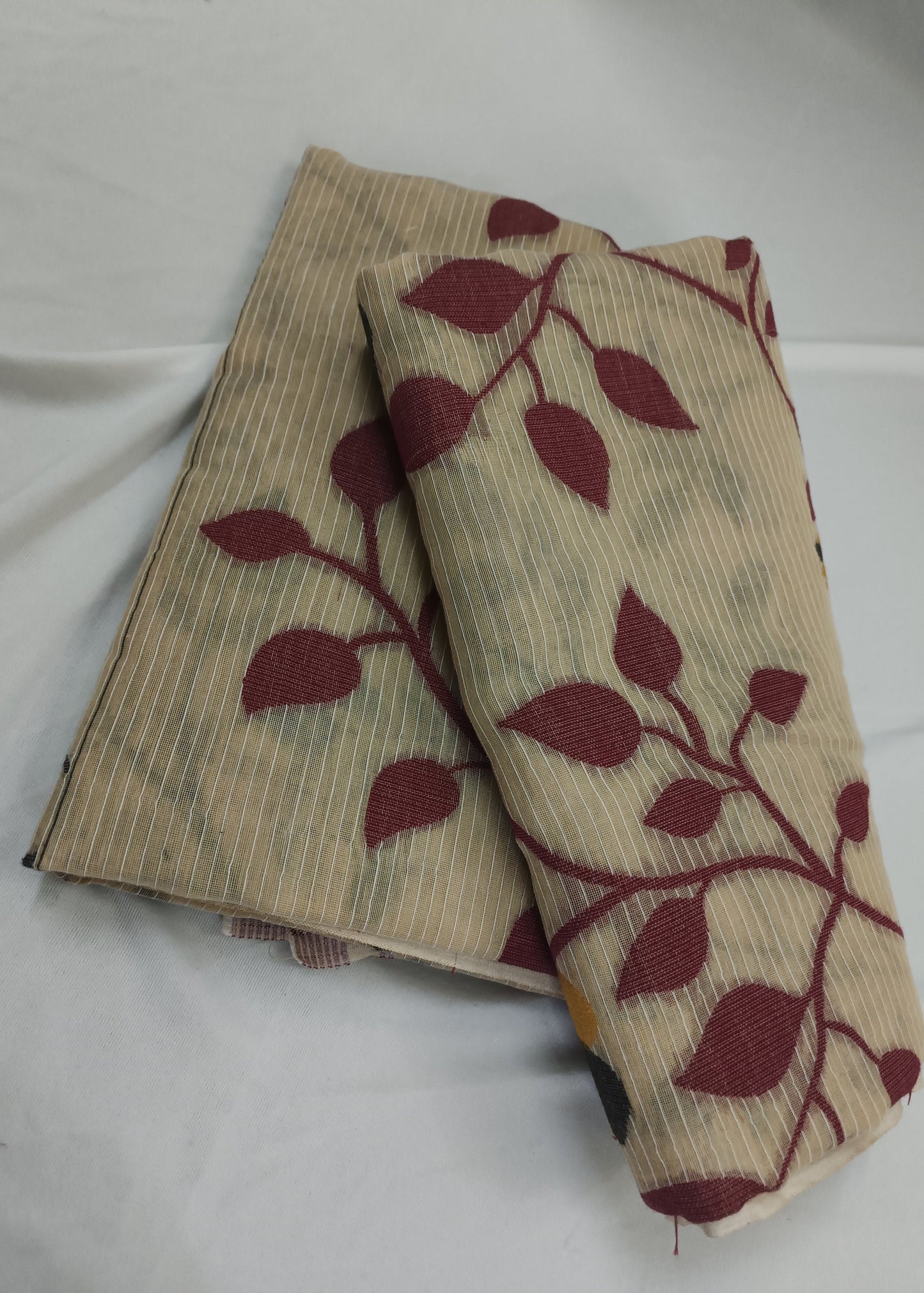 Beige socks with red leaf pattern on a white background