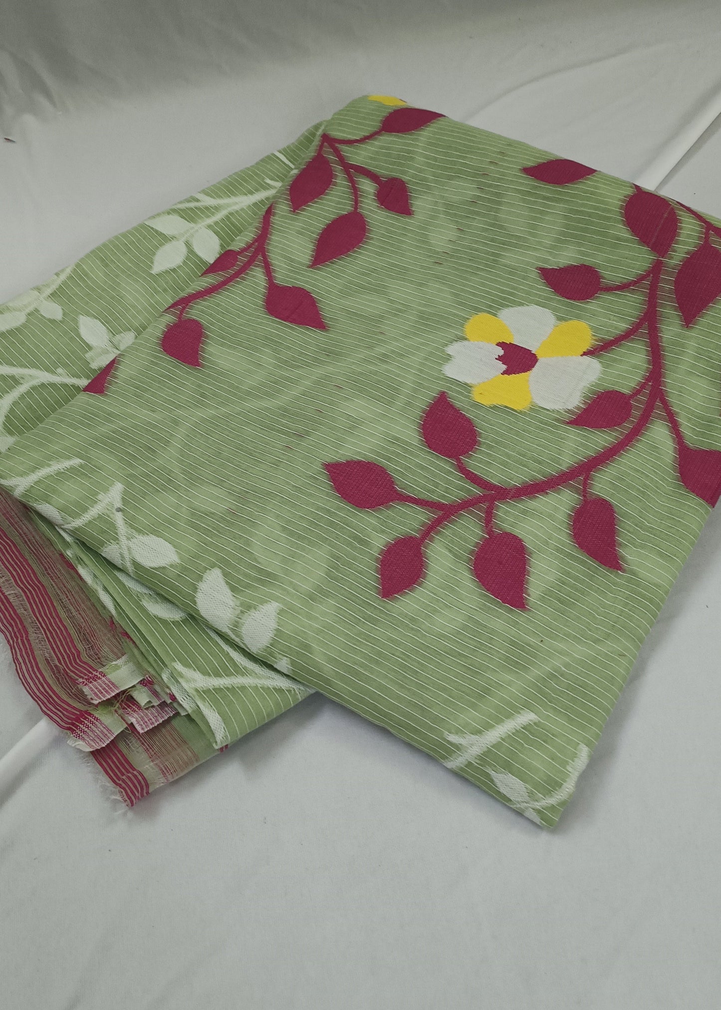 Green fabric with floral patterns on a white background