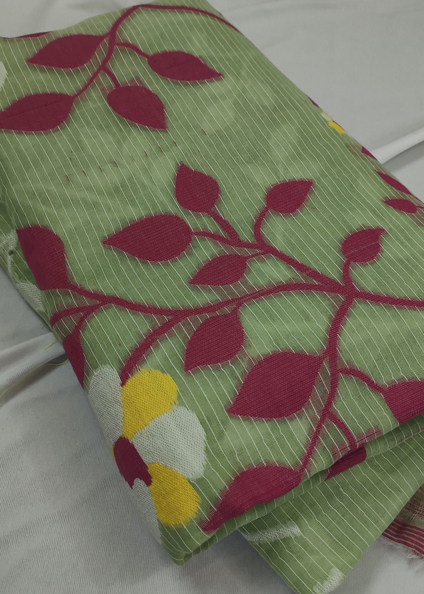 Folded fabric with leaf pattern on a white background