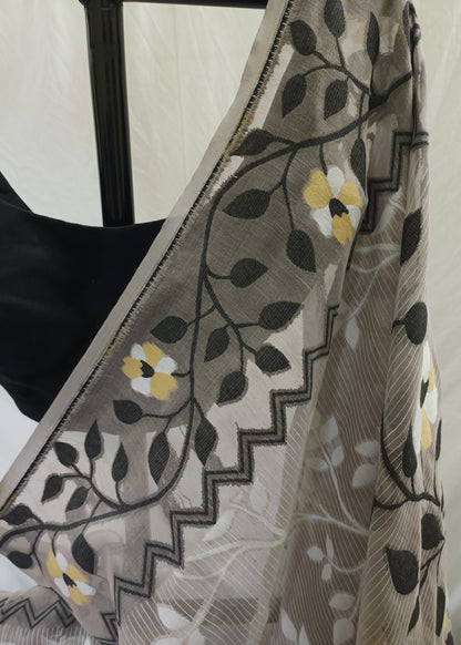 Close-up of a floral patterned fabric with black, yellow, and white colors.
