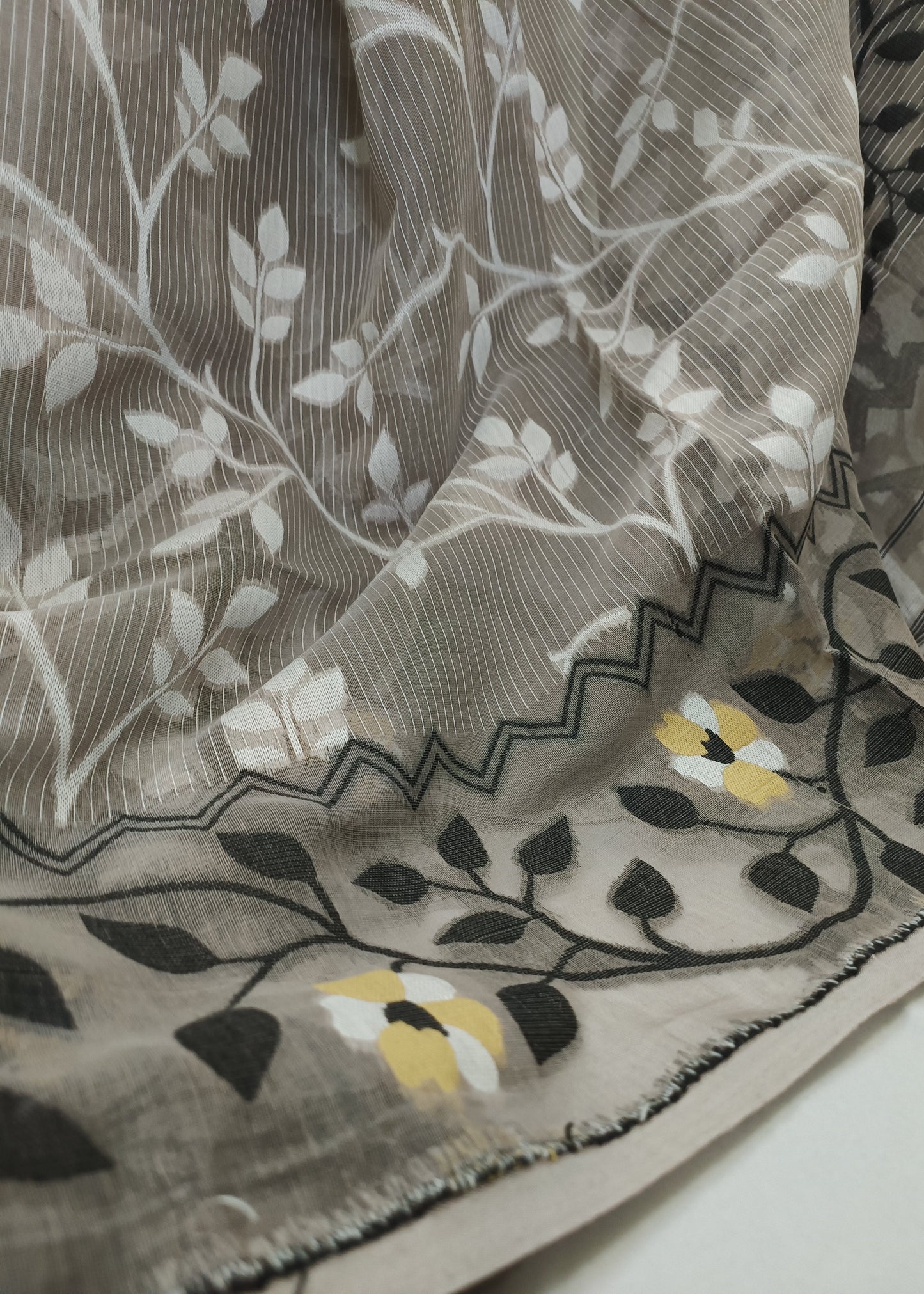 Close-up of a floral patterned fabric with leaves and flowers.