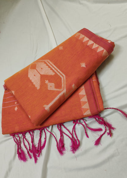 Orange scarf with pink tassels on a white fabric background
