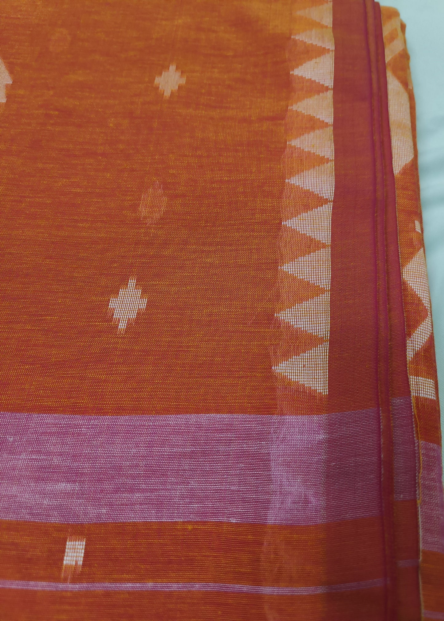 Traditional fabric with intricate patterns on a plain background
