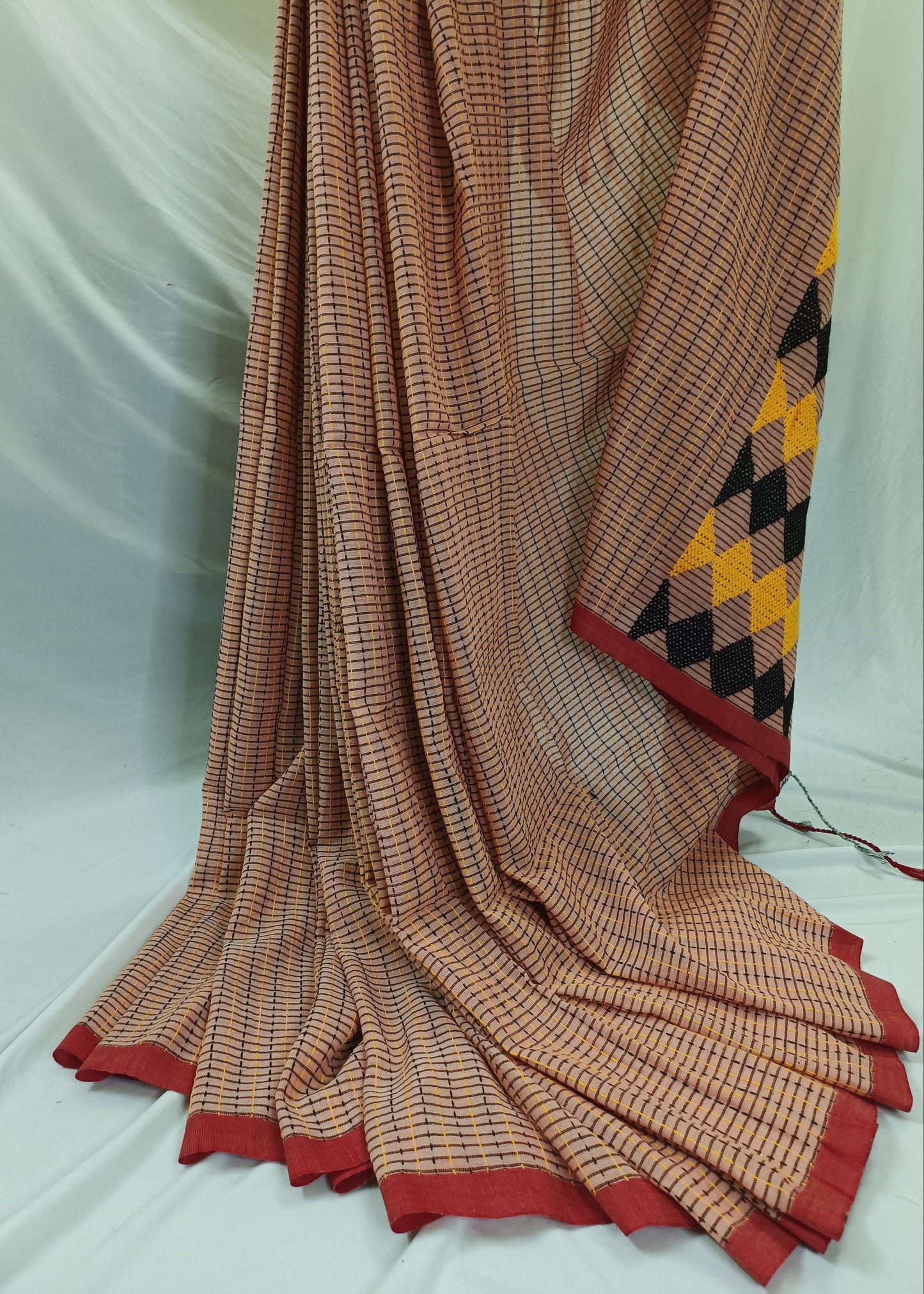Sari with a geometric pattern draped over a white background
