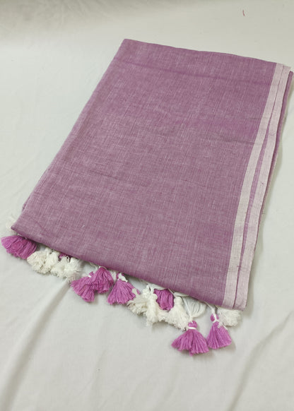 Purple fabric with white lace and pink tassels on a light gray background