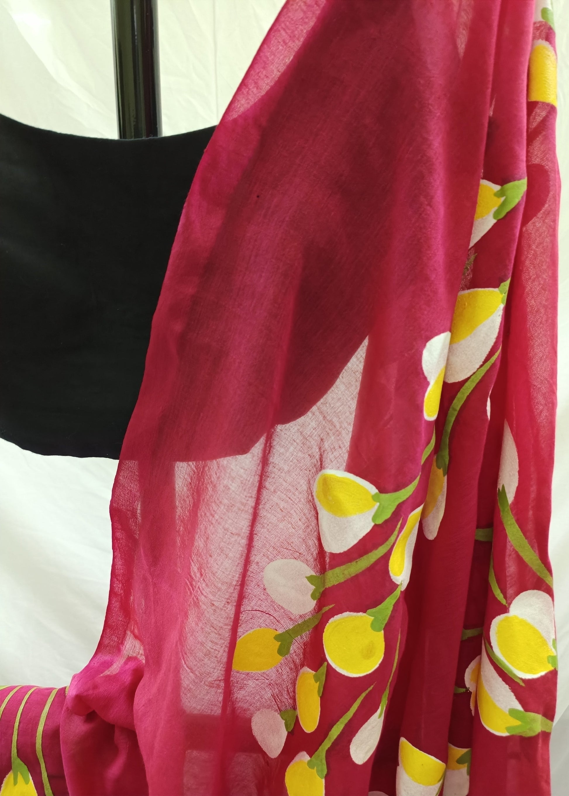 Red fabric with yellow floral patterns on a white background