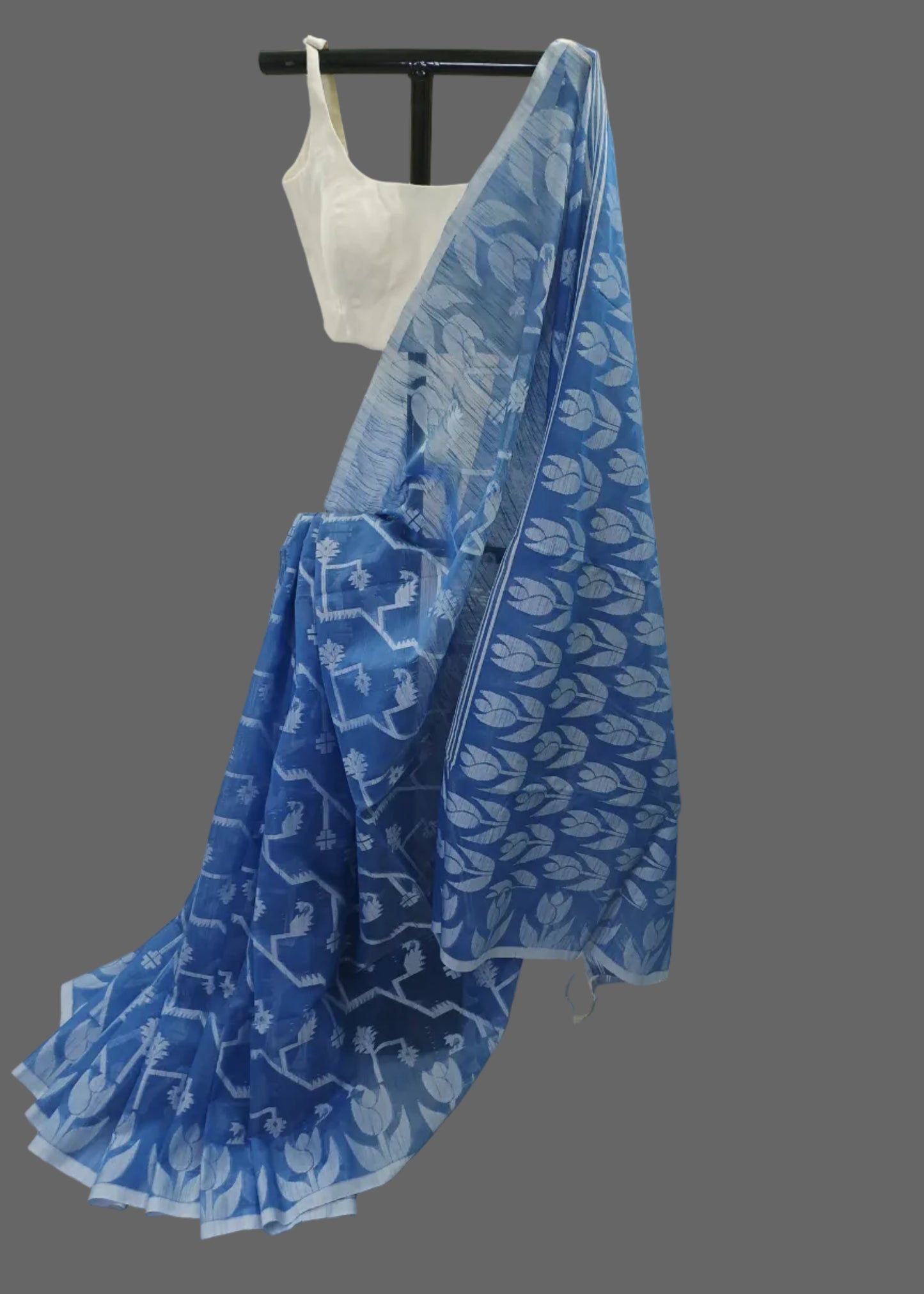 Blue patterned fabric draped over a white background