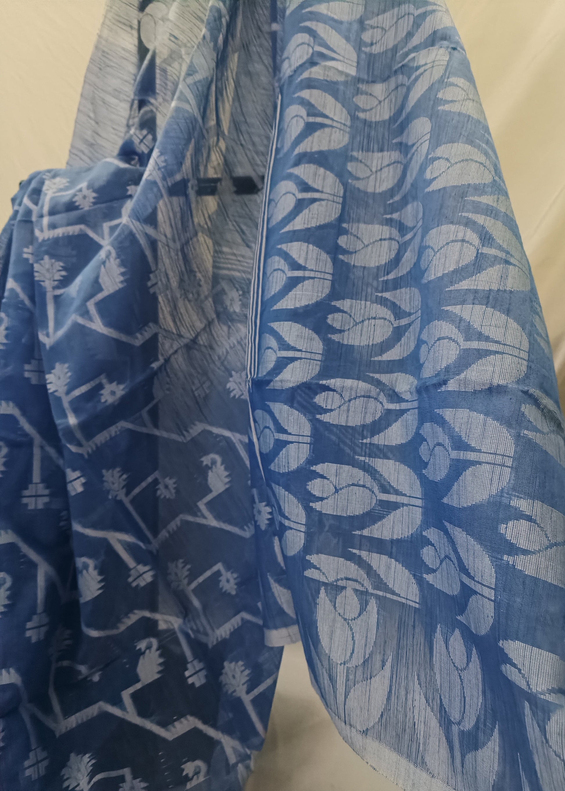 Blue fabric with white patterns draped over a surface