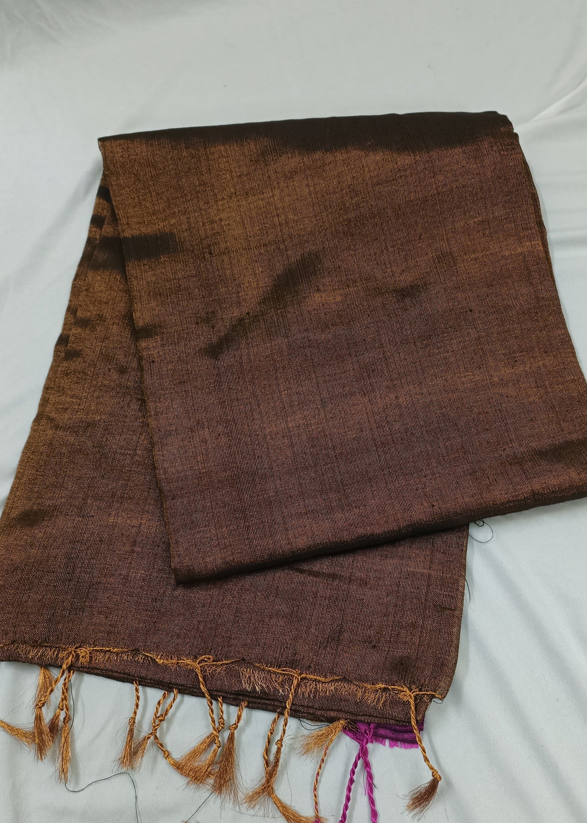 Brown saree with fringes on a white background