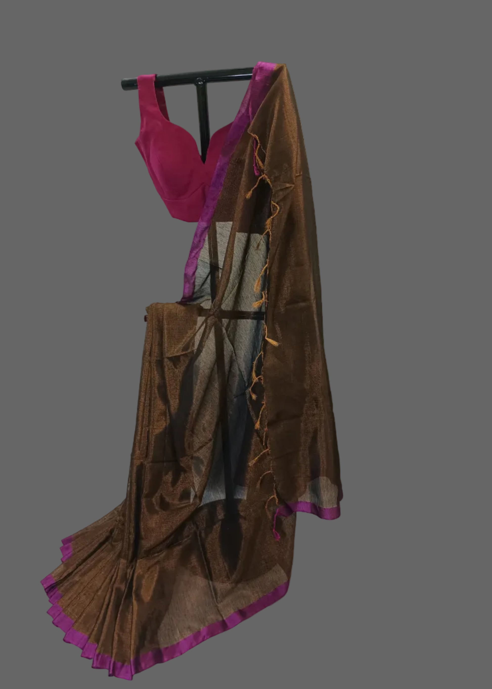Brown saree with purple border draped over a mannequin against a white background