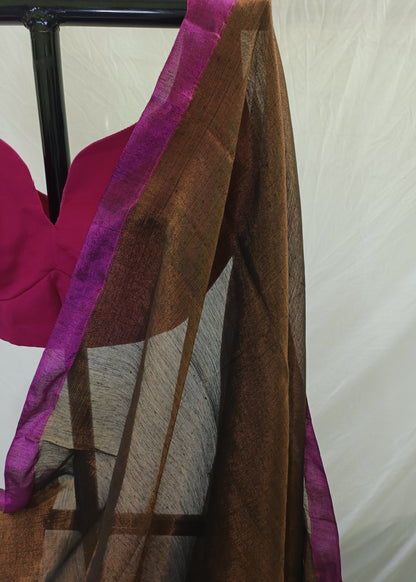 Brown fabric with purple trim draped over a chair against a neutral background