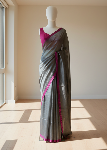 Gray linen saree with pink border on a mannequin against a neutral background