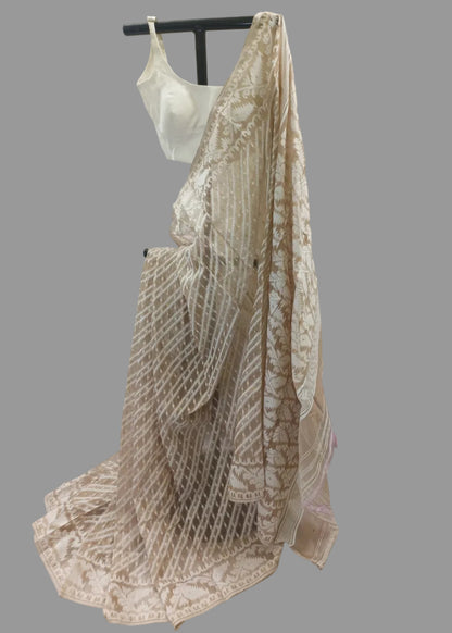 Beige and brown patterned saree draped over a mannequin against a plain background