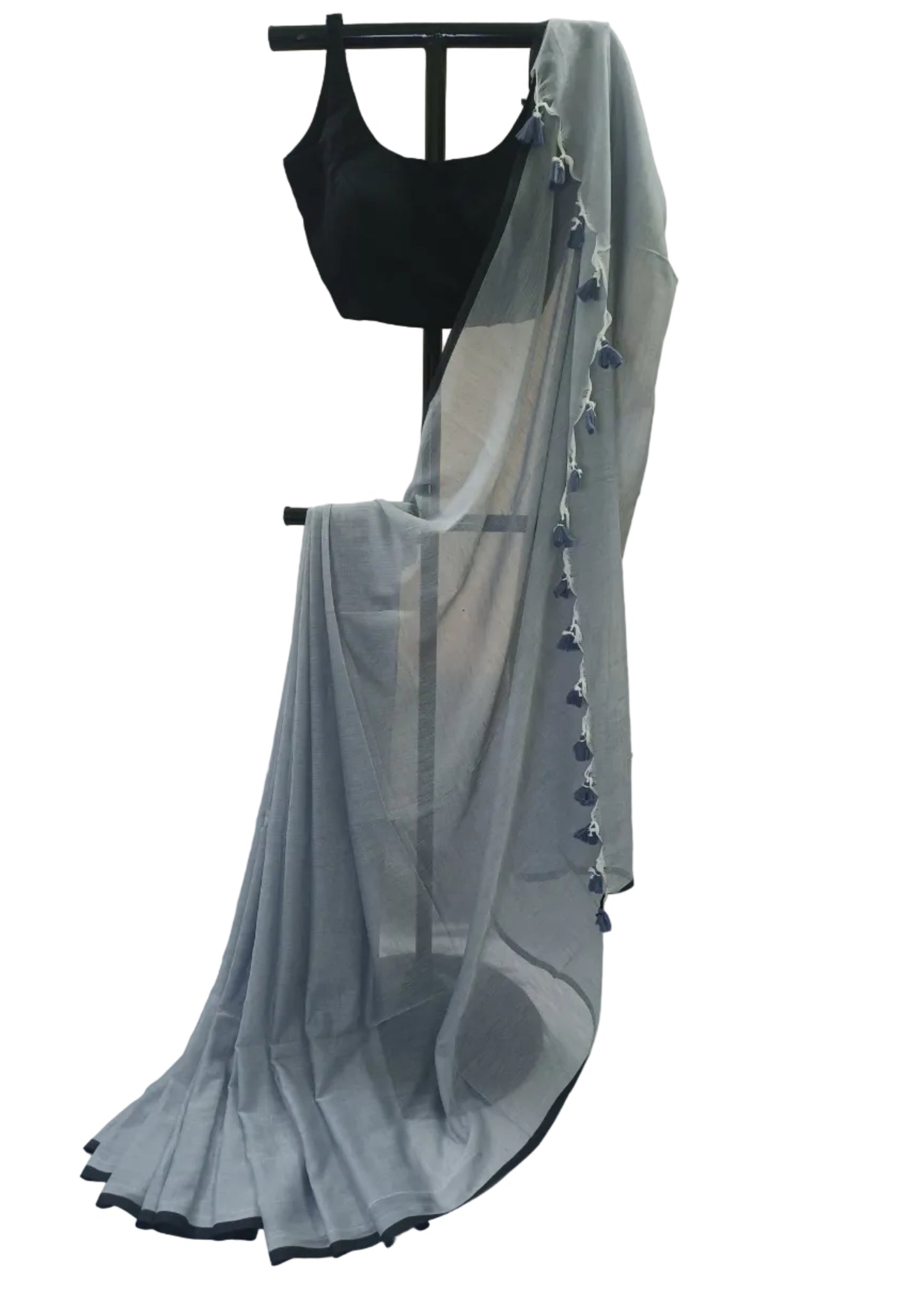 Gray saree with black border on a mannequin against a beige background