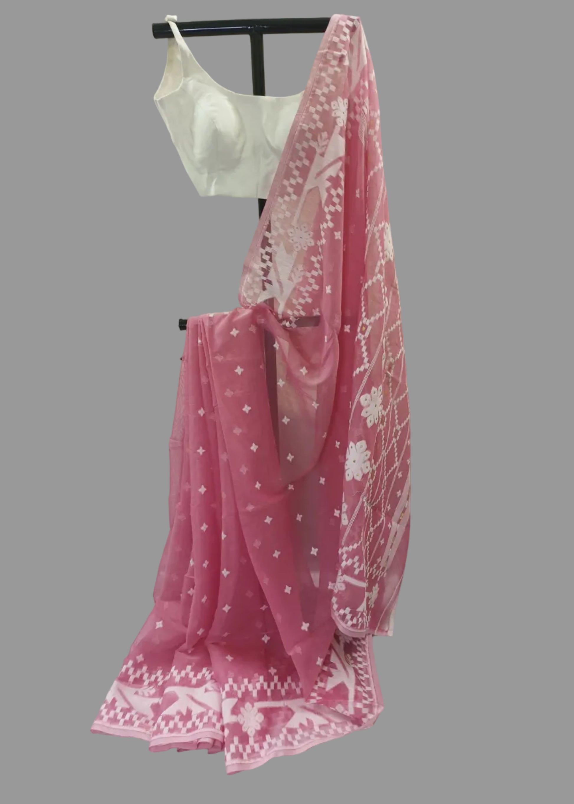 Pink saree with white patterns on a white background