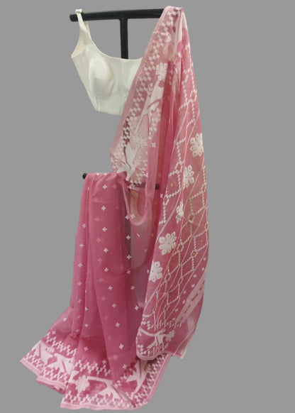 Pink saree with white patterns on a mannequin against a plain background