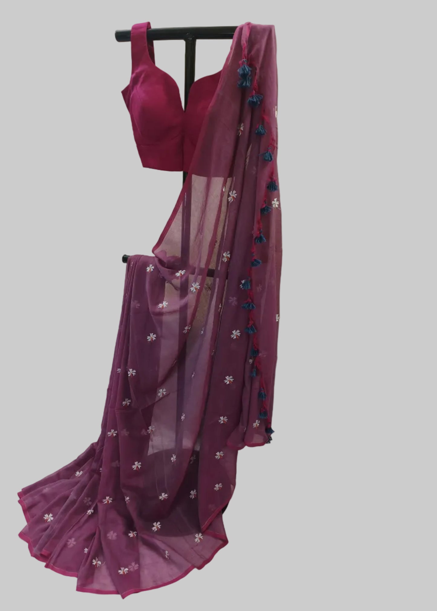 Purple saree with floral patterns on a white background