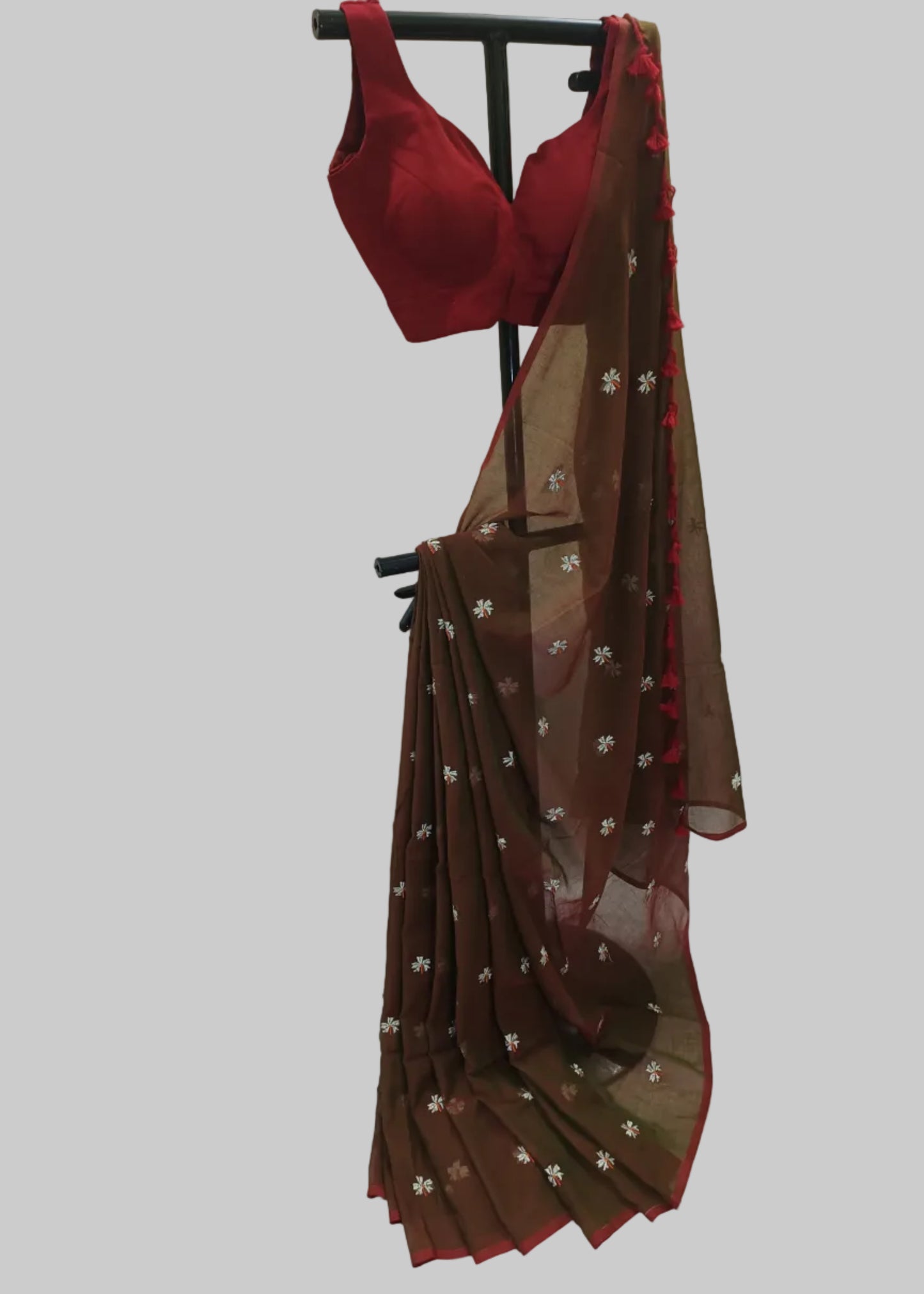Red bra and brown saree with floral patterns on a white background