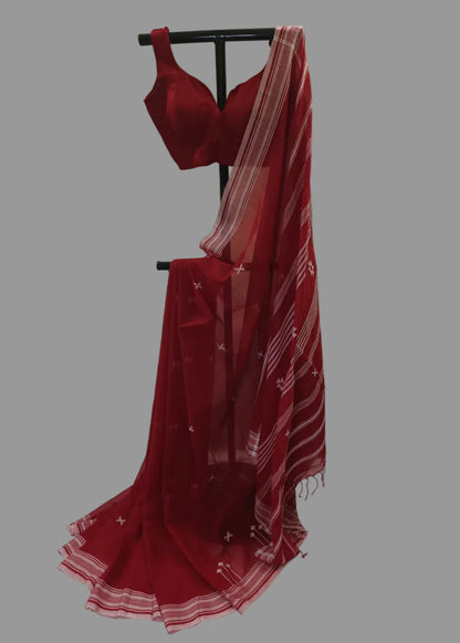 Red saree with a matching blouse on a stand against a white background