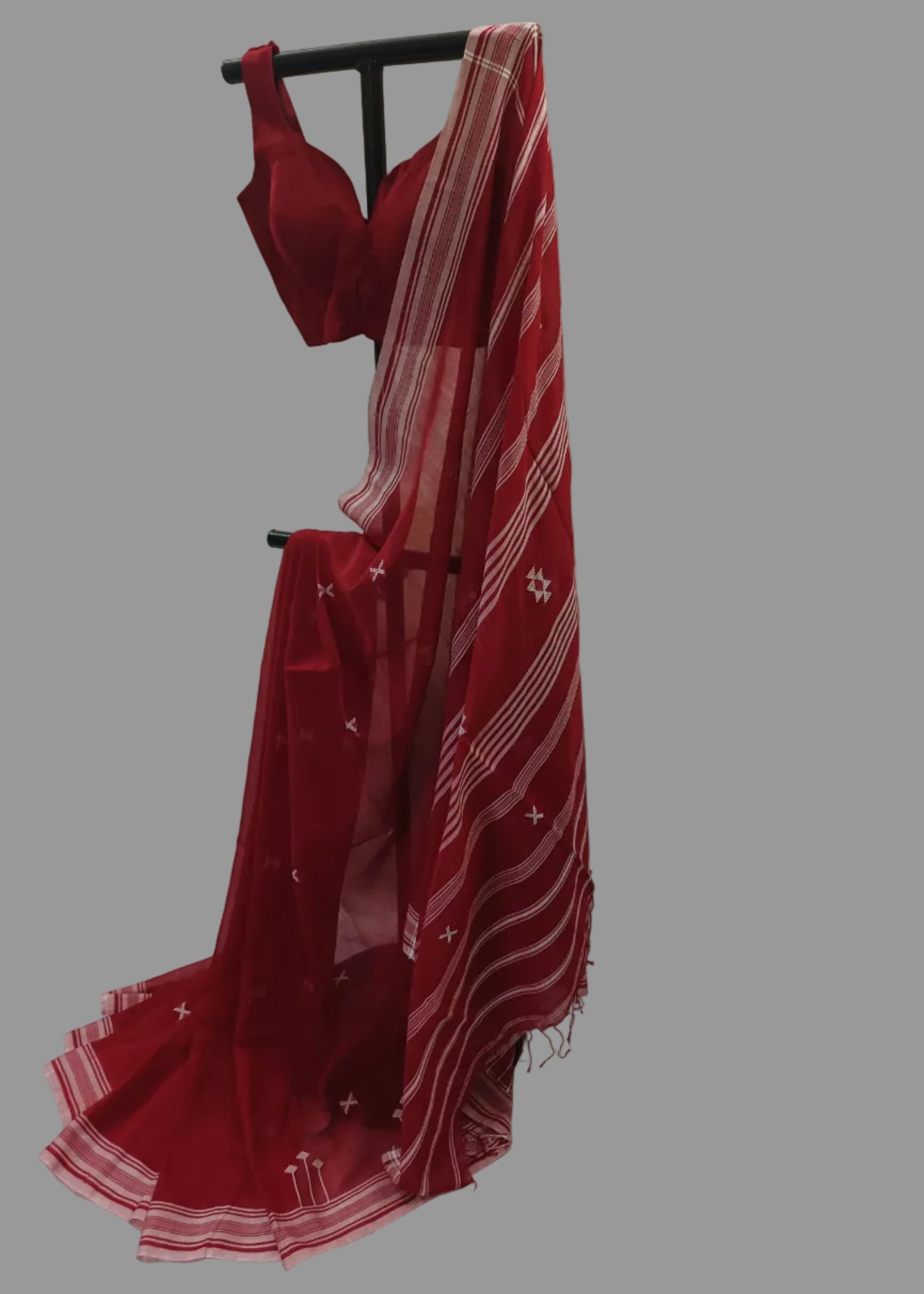 Red saree with white patterns on a white background