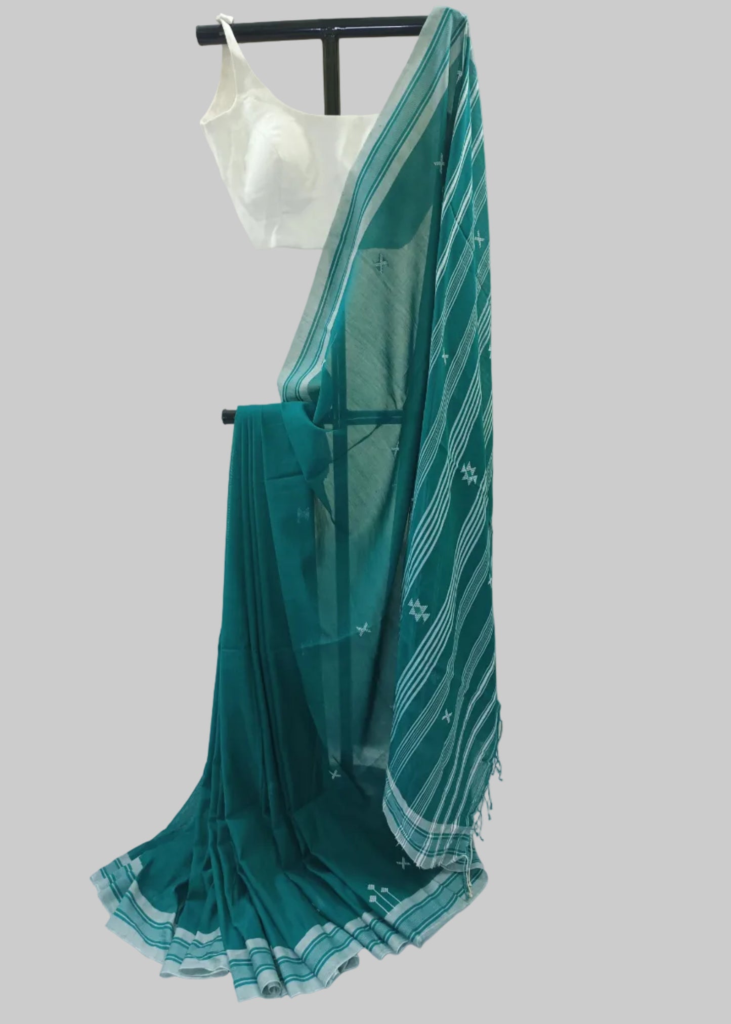 Teal saree with white stripes on a white background
