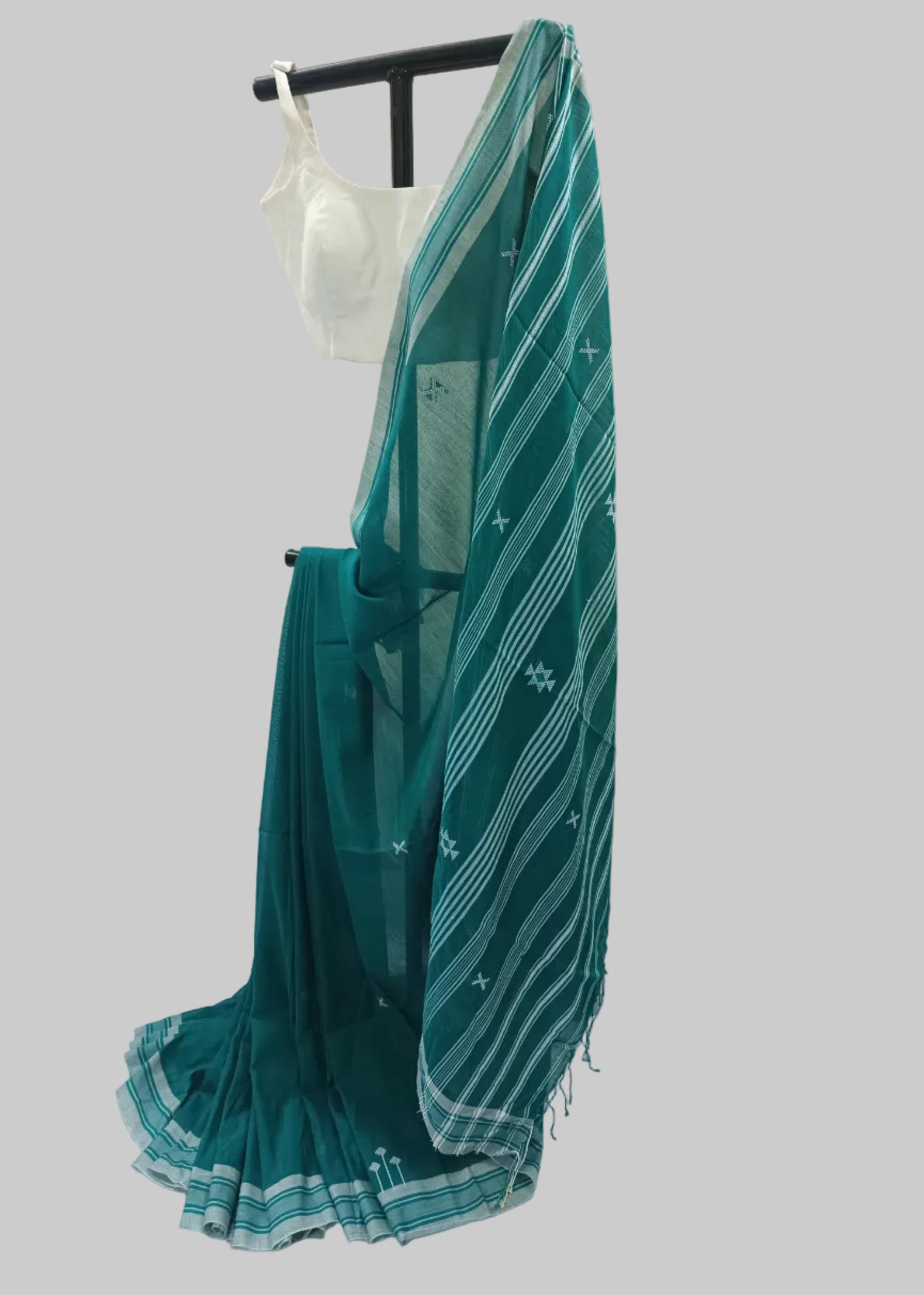 Green saree with white patterns on a white background
