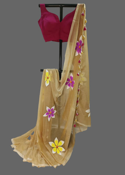Beige saree with floral patterns draped over a mannequin against a plain background