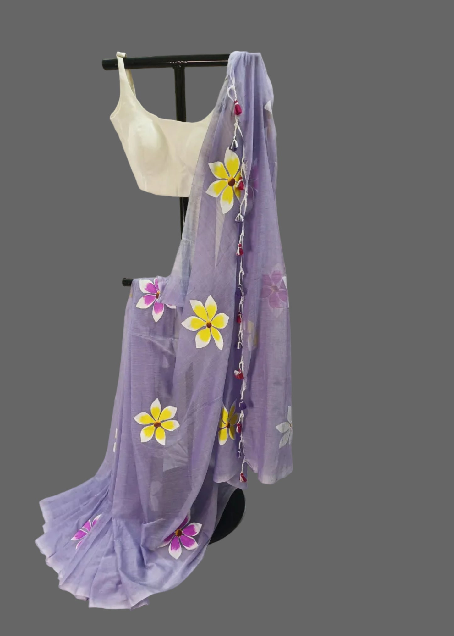 Lavender saree with floral designs on a mannequin against a plain background