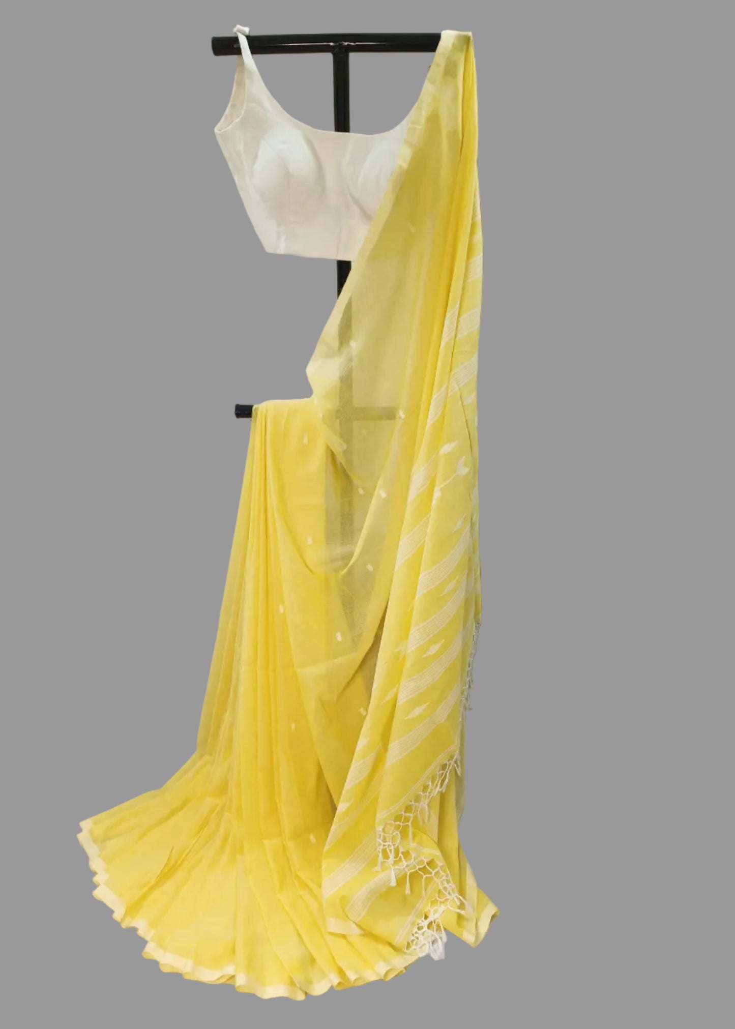 Yellow saree draped over a white background