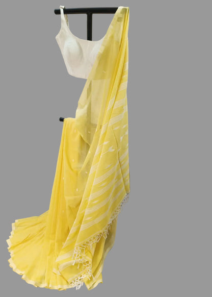 Yellow saree draped over a mannequin against a white background