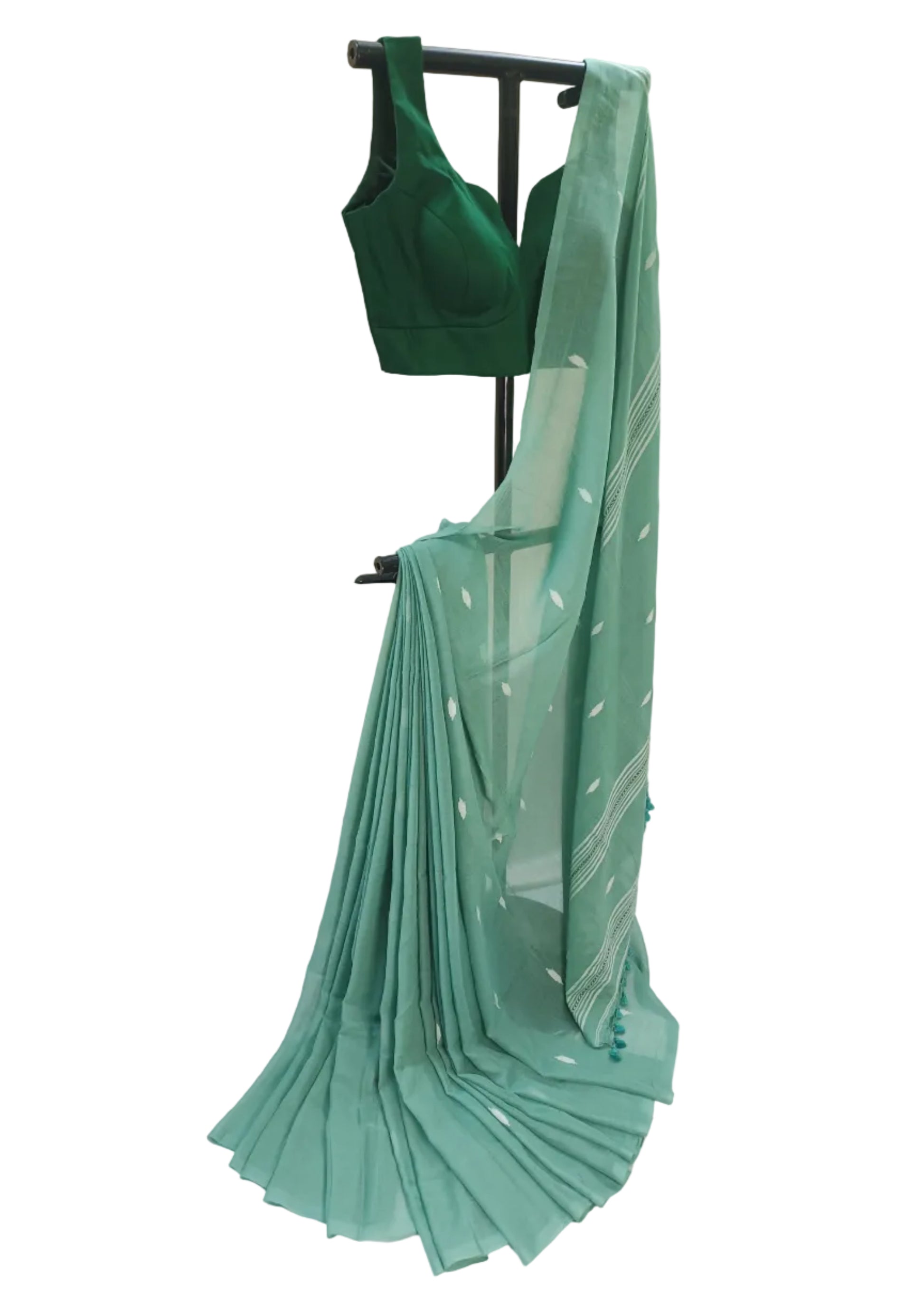 Green saree and blouse on a stand against a white background