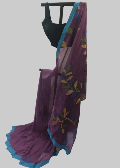 A purple saree with a blue border and multicolor floral print, draped over a black dress form against a white fabric backdrop.