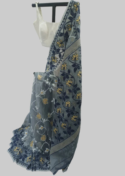 A blue and gray printed saree with yellow floral motifs and a white blouse, displayed on a black hanger against a white fabric backdrop.