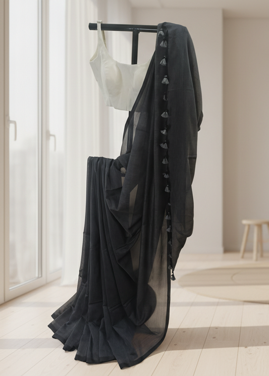 Black sheer skirt with a white top on a mannequin against a neutral background